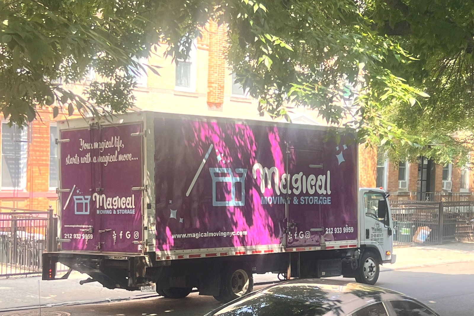 Moving in NYC in July 2026: Magical Moving truck loading on a NYC street during the end-of-June rush