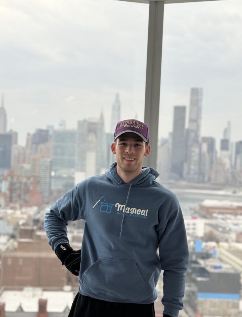 NYC to NJ movers: Magical Moving crew member with the Manhattan skyline across the Hudson behind him