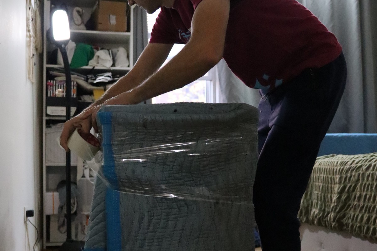 Mover shrink wrapping a cabinet whole instead of taking it apart