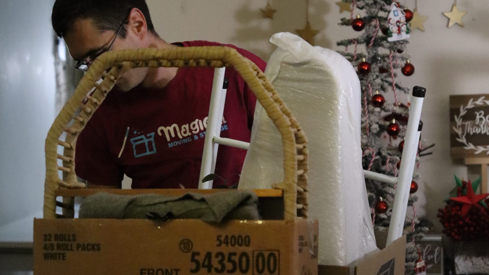 Magical Moving crew boxing a large awkward item, one of the things movers charge extra for in NYC