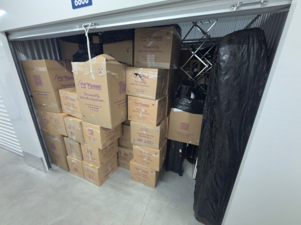 Boxes and wrapped furniture held in a Magical Moving storage unit between move out and closing