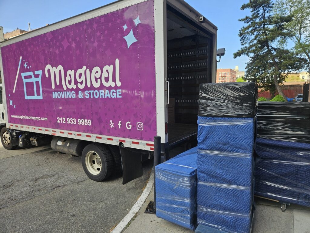 Wrapped furniture loaded at a Magical Moving truck, ready to stay on board overnight after a delayed closing