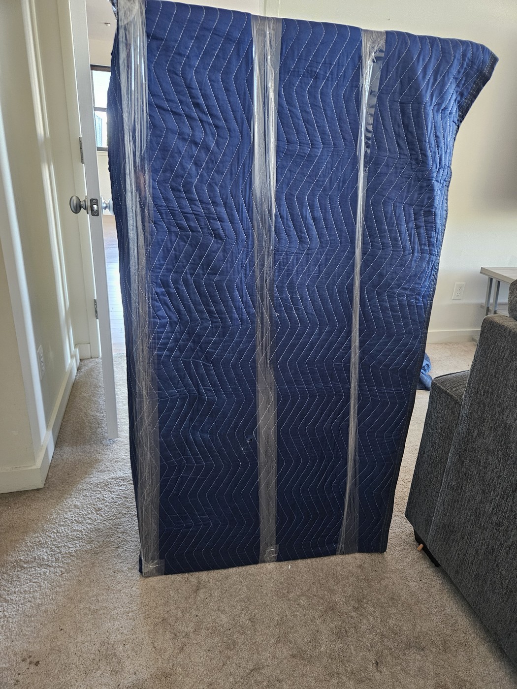 A wardrobe wrapped in moving blankets, a special handling item to look for on a NYC moving quote