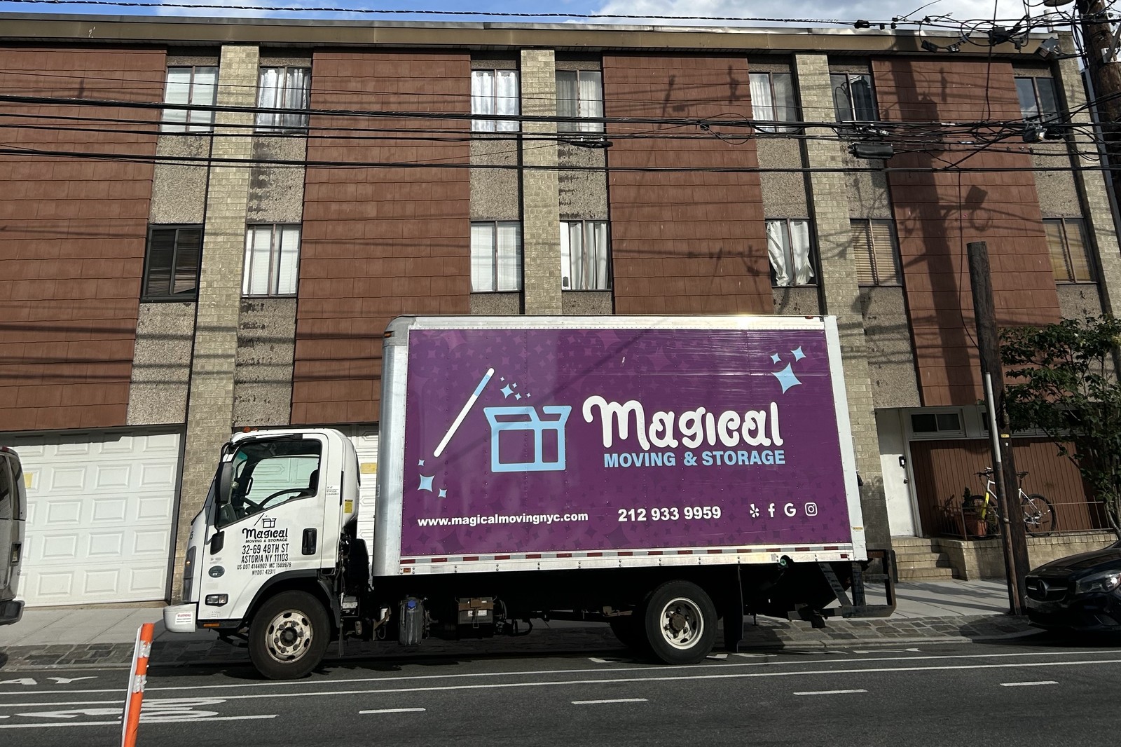 Magical Moving truck outside a NYC apartment building for a delayed closing move