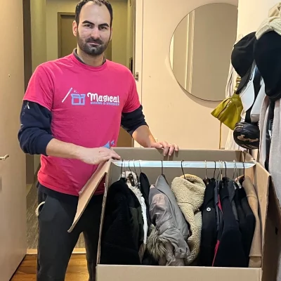 Top-notch mover packing clothes in an apartment