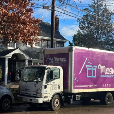 moving company truck parked in front of a house in Queens, waiting for loading items
